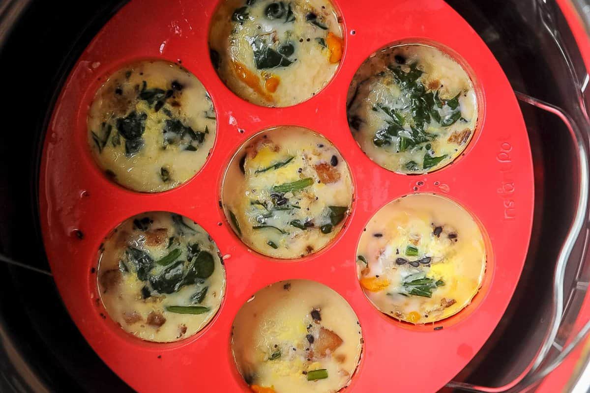 egg bites in red silicone egg mold in the instant pot.