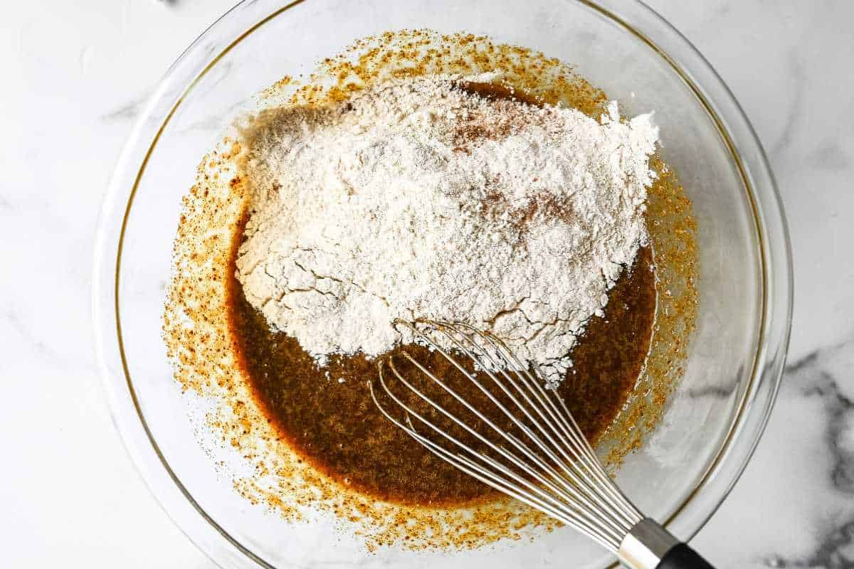 dry ingredients being mixed into wet ingredients.