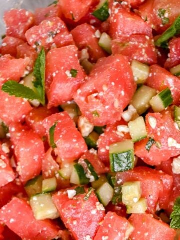featured image close up of watermelon basil salad with cucumbers and feta.