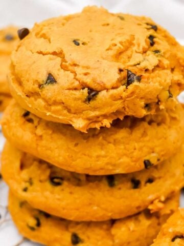 close up shot of a stack of cake mix pumpkin cookies.