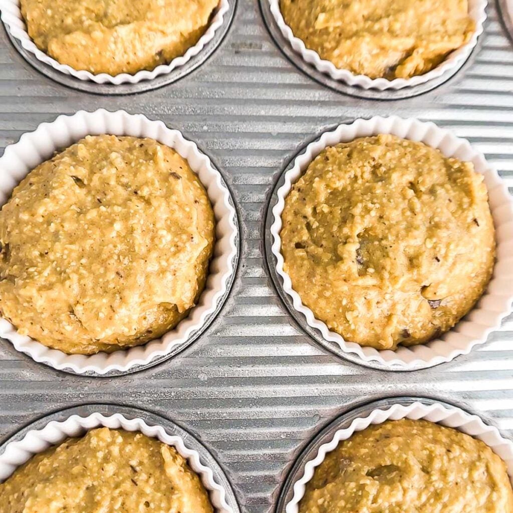 unbaked muffins in a muffin tin.
