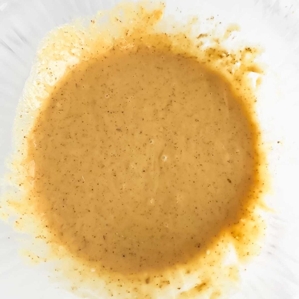 wet muffin batter in a large glass bowl.